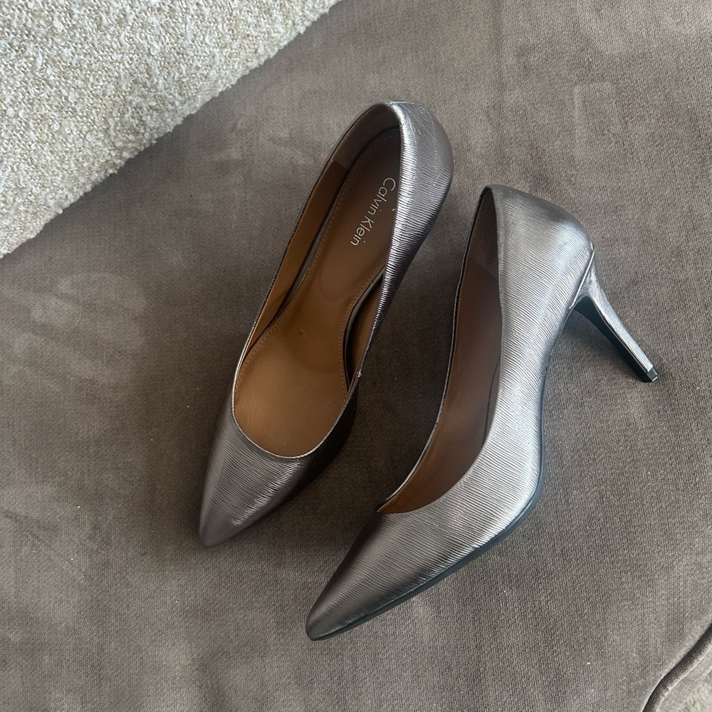 Beautiful pair of ‘barely worn’ Calvin Klein Silver 3” Women’s Heels.